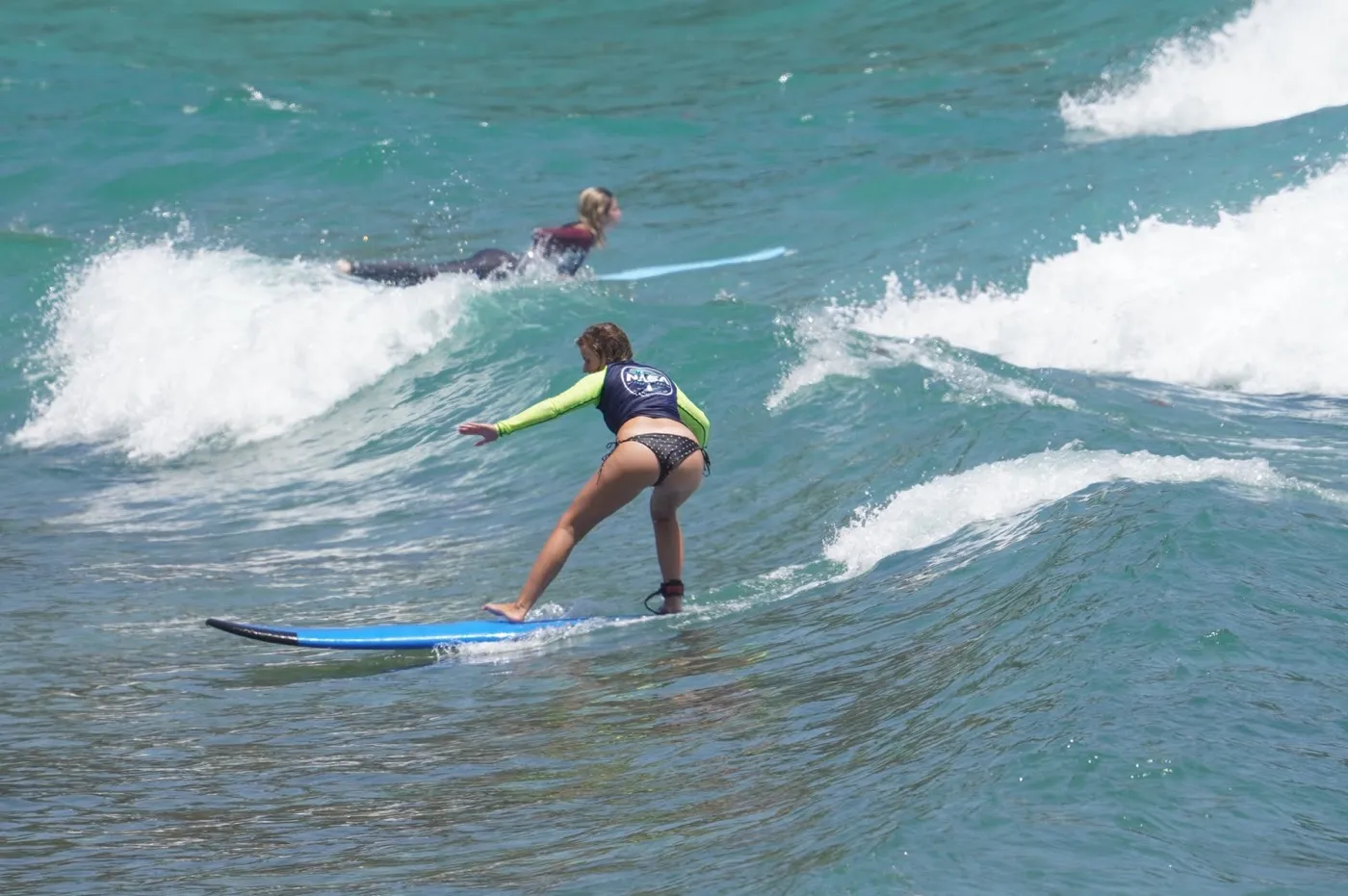 Beginner surfer practising on a wave at Balangan Beach