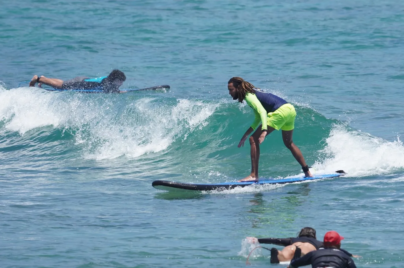 NASA Surf School coach riding a wave at Balangan Beach